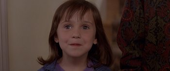Movie still from “Mrs. Doubtfire” (1993), directed by Chris Columbus – A little girl is looking up at the camera; Close Up shot, Over the shoulder angle