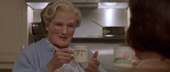 Movie still from “Mrs. Doubtfire” (1993), directed by Chris Columbus – An older woman holding a coffee mug in a kitchen; Close Up shot, Low angle