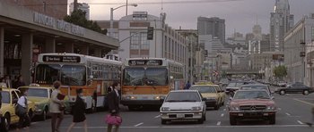 Movie still from “Mrs. Doubtfire” (1993), directed by Chris Columbus – A city street with a bus and cars on the side of the road; Extreme Wide shot, Low angle