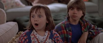 Movie still from “Mrs. Doubtfire” (1993), directed by Chris Columbus – Two children are looking surprised at something in the background; Close Up shot, Low angle
