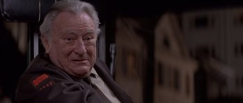 Movie still from “Mrs. Doubtfire” (1993), directed by Chris Columbus – An older man sitting in front of a window; Close Up shot, Low angle