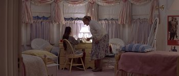 Movie still from “Mrs. Doubtfire” (1993), directed by Chris Columbus – A woman and a girl are sitting at a desk; Wide shot, High angle