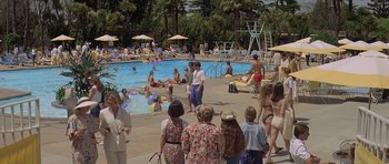 Movie still from “Mrs. Doubtfire” (1993), directed by Chris Columbus – A group of people standing around a swimming pool; Extreme Wide shot, High angle