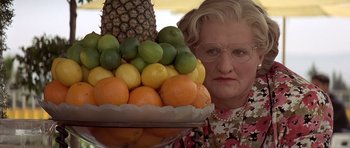 Movie still from “Mrs. Doubtfire” (1993), directed by Chris Columbus – An older woman holding a tray of fruit; Close Up shot, Low angle