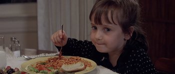 Movie still from “Mrs. Doubtfire” (1993), directed by Chris Columbus – A little girl sitting in front of a plate of spaghetti; Close Up shot, High angle