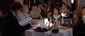 Movie still from “Mrs. Doubtfire” (1993), directed by Chris Columbus – Two people are sitting at a table in a restaurant; Medium shot, Over the shoulder angle