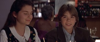 Movie still from “Mrs. Doubtfire” (1993), directed by Chris Columbus – A young boy and a young girl sitting at a table; Close Up shot, Over the shoulder angle