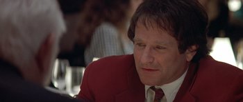 Movie still from “Mrs. Doubtfire” (1993), directed by Chris Columbus – A person wearing a suit and tie; Close Up shot, Over the shoulder angle