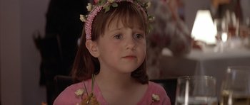 Movie still from “Mrs. Doubtfire” (1993), directed by Chris Columbus – A little girl wearing a pink shirt and a flower crown; Close Up shot, Over the shoulder angle