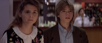 Movie still from “Mrs. Doubtfire” (1993), directed by Chris Columbus – A couple of people standing next to each other in a room; Close Up shot, Low angle