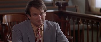Movie still from “Mrs. Doubtfire” (1993), directed by Chris Columbus – A person wearing a suit and a tie; Close Up shot, Over the shoulder angle
