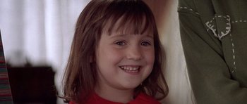 Movie still from “Mrs. Doubtfire” (1993), directed by Chris Columbus – A young girl smiling for the camera; Close Up shot, High angle