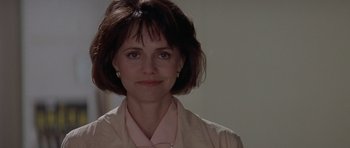 Movie still from “Mrs. Doubtfire” (1993), directed by Chris Columbus – A person with short hair wearing a shirt and tie; Close Up shot, Over the shoulder angle