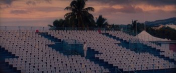 A man standing in front of rows of white chairs
