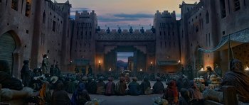 Movie still from “Padmaavat” (2018), directed by Sanjay Leela Bhansali – A group of people sitting in front of a building; Extreme Wide shot, Low angle