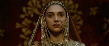 Movie still from “Padmaavat” (2018), directed by Sanjay Leela Bhansali – A woman with a nose ring and a gold chain around her neck; Close Up shot, Over the shoulder angle