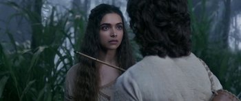 Movie still from “Padmaavat” (2018), directed by Sanjay Leela Bhansali – A woman with long dark hair holding a stick in front of another woman; Close Up shot, Over the shoulder angle