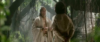 Movie still from “Padmaavat” (2018), directed by Sanjay Leela Bhansali – A man standing next to another man in a forest; Medium shot, Over the shoulder angle