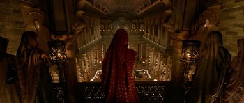 Movie still from “Padmaavat” (2018), directed by Sanjay Leela Bhansali – A woman in a red veil standing in a large building; Extreme Wide shot, Low angle