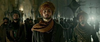 Movie still from “Padmaavat” (2018), directed by Sanjay Leela Bhansali – A man with a turban and beard standing in front of a group of people; Close Up shot, Low angle