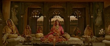Movie still from “Padmaavat” (2018), directed by Sanjay Leela Bhansali – An indian woman sitting on a couch in front of a mirror; Wide shot, Overhead angle