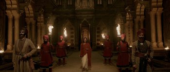 Movie still from “Padmaavat” (2018), directed by Sanjay Leela Bhansali – A group of men standing in front of a building; Wide shot, Low angle