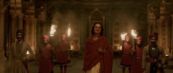 Movie still from “Padmaavat” (2018), directed by Sanjay Leela Bhansali – A man standing in front of a group of people; Medium shot, Low angle