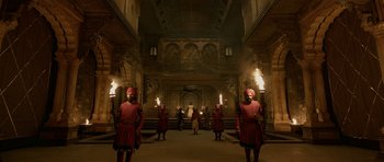 Movie still from “Padmaavat” (2018), directed by Sanjay Leela Bhansali – A group of men in red robes holding torches in a building; Extreme Wide shot, Low angle