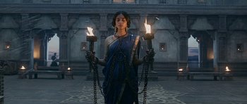 Movie still from “Padmaavat” (2018), directed by Sanjay Leela Bhansali – A woman holding two torches in chains; Medium shot, Low angle