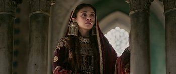 Movie still from “Padmaavat” (2018), directed by Sanjay Leela Bhansali – A woman in a red and gold dress with a gold earring; Close Up shot, Over the shoulder angle