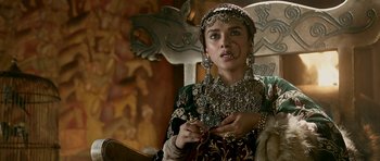 Movie still from “Padmaavat” (2018), directed by Sanjay Leela Bhansali – A woman in a green and gold dress holding a sword in her hand; Close Up shot, Over the shoulder angle