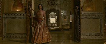 Movie still from “Padmaavat” (2018), directed by Sanjay Leela Bhansali – A woman dressed in a pink and gold dress; Wide shot, Over the shoulder angle