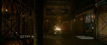 Movie still from “Padmaavat” (2018), directed by Sanjay Leela Bhansali – A man sitting in front of a fire in a room; Extreme Wide shot, High angle