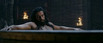 A man with long black hair and a long beard