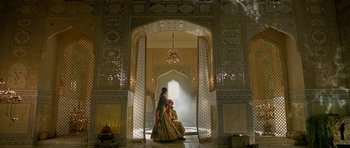 Movie still from “Padmaavat” (2018), directed by Sanjay Leela Bhansali – Two people in a room that has a lot of decorations on the walls; Extreme Wide shot, Low angle