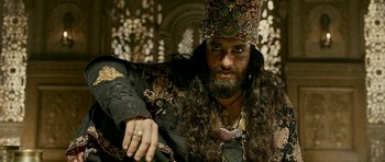 Movie still from “Padmaavat” (2018), directed by Sanjay Leela Bhansali – A man with long hair and a beard wearing a crown; Close Up shot, Low angle