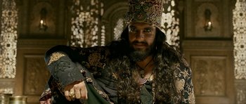 Movie still from “Padmaavat” (2018), directed by Sanjay Leela Bhansali – A man with long hair and a beard wearing a crown; Close Up shot, Low angle
