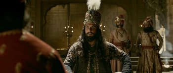 Movie still from “Padmaavat” (2018), directed by Sanjay Leela Bhansali – A man with a long beard wearing a crown; Close Up shot, Over the shoulder angle