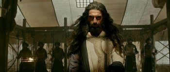 Movie still from “Padmaavat” (2018), directed by Sanjay Leela Bhansali – A man with long black hair and a long beard; Medium shot, Low angle