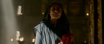 Movie still from “Padmaavat” (2018), directed by Sanjay Leela Bhansali – An old woman wearing a black veil and holding a red bag; Close Up shot, Low angle