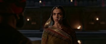 Movie still from “Padmaavat” (2018), directed by Sanjay Leela Bhansali – A woman in a traditional indian dress with a nose ring; Close Up shot, Over the shoulder angle