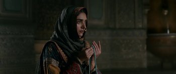 Movie still from “Padmaavat” (2018), directed by Sanjay Leela Bhansali – A woman in a black headscarf holding a rosary; Close Up shot, Over the shoulder angle