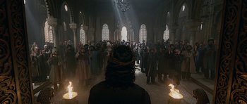 Movie still from “Padmaavat” (2018), directed by Sanjay Leela Bhansali – A group of people standing in a room with candles; Wide shot, Low angle