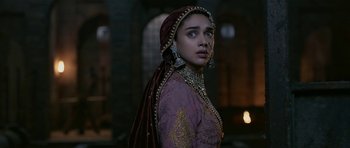 Movie still from “Padmaavat” (2018), directed by Sanjay Leela Bhansali – A woman in a purple and gold dress with a veil; Close Up shot, Over the shoulder angle