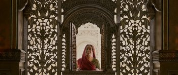 Movie still from “Padmaavat” (2018), directed by Sanjay Leela Bhansali – A woman wearing a red veil standing in a window; Medium shot, Low angle