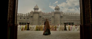 Movie still from “Padmaavat” (2018), directed by Sanjay Leela Bhansali – A group of people standing in front of a castle; Extreme Wide shot, Low angle