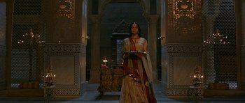 Movie still from “Padmaavat” (2018), directed by Sanjay Leela Bhansali – A woman holding a tray of food standing in an ornate room; Wide shot, Low angle
