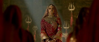 Movie still from “Padmaavat” (2018), directed by Sanjay Leela Bhansali – A woman dressed in a red and gold dress; Medium shot, Over the shoulder angle