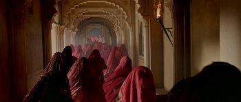 Movie still from “Padmaavat” (2018), directed by Sanjay Leela Bhansali – A group of people in red robes walking down a hallway; Extreme Wide shot, High angle