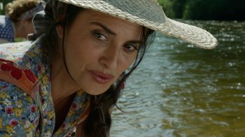 Movie still from “Pain and Glory” (2019), directed by Pedro Almodóvar – A person wearing a hat near a body of water; Close Up shot, High angle